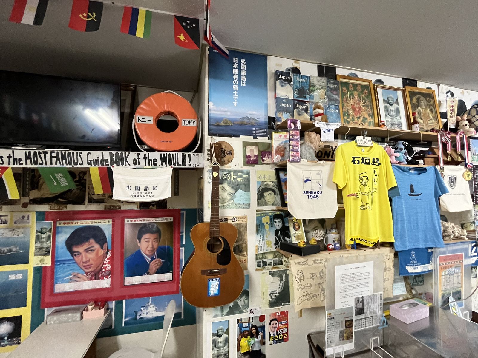 ギターやTシャツ、ポスターが飾られた栄福食堂の店内の壁